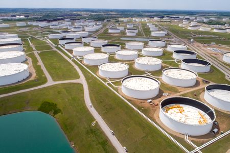 Oil settle lower despite record US crude stock drawdown
