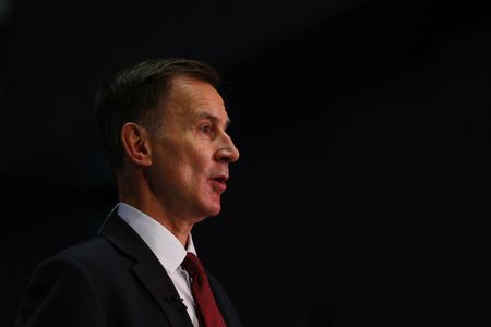 UK’s Hunt tries to defuse tax row with cuts to government staff